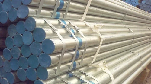 A group of workers at a GI pipe manufacturing facility.